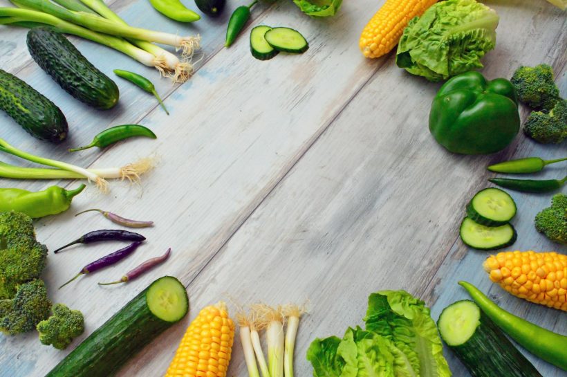 An assortment of fresh vegetables on a wooden table, perfect for healthy cooking.